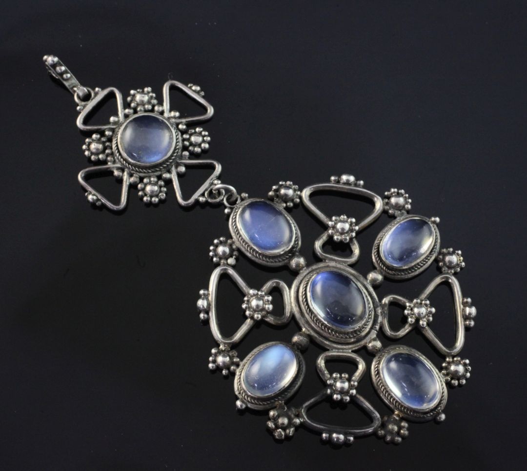 An early 20th century Arts & Crafts silver and moonstone drop pendant, of circular and cruciform