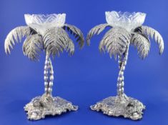 A pair of late Victorian electro plated centrepieces, each modelled as two palm trees on rustic