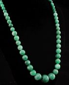 A single strand graduated green hardstone bead necklace, with octagonal barrel shaped clasp, 18in.