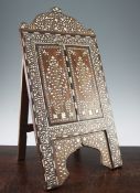 An Indian ebony and ivory inlaid easel mirror, profusely decorated with flowers, leaves and