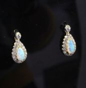 A pair of early 20th century gold, white opal and diamond drop earrings, each set with pear shaped