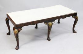 A Queen Anne style walnut and parcel gilt rectangular stool, on six shell carved cabriole legs,