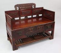 A Chinese red lacquer hall seat, the back and arms inset with traditional panels decorated with