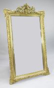 A large rectangular gilt gesso wall mirror, with pierced and floral crest, central shell motif and