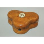 A 19th century fruitwood triform shaped gaming token box, containing circular and oblong ivory