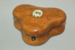 A 19th century fruitwood triform shaped gaming token box, containing circular and oblong ivory