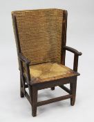 A small Orkney pine and skep-work open armchair, with scroll arms