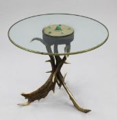 Anthony Redmile. A circular glass top occasional table, centred with raised cabochon malachite