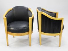 A pair of Art Deco satin birch and black leather upholstered tub chairs, by Maurice Adams, each with