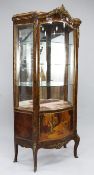 A Louis XV style rosewood and ormolu mounted serpentine shape vitrine, the single glazed door with a
