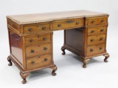 An early 20th century mahogany pedestal desk, with inverted breakfront, gadrooned moulded border and