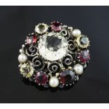 An early 20th century Arts & Crafts silver, citrine, garnet and split pearl set clip. of oval