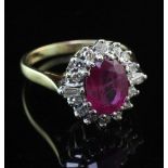 An 18ct gold, ruby and diamond oval cluster ring, the oval cut ruby weighing approximately 1.50-2.