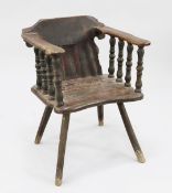 A 19th century primitive armchair, with pine arms and back, and shaped slab seat, on baluster turned
