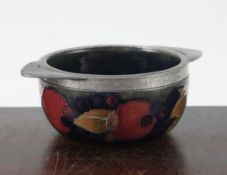 A Moorcroft pomegranate and Tudric pewter mounted quaich, 1920's, the mount stamped Tudric Moorcroft