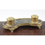 A French Empire style ormolu and marble kidney shape inkstand, on paw feet, 12.5in.