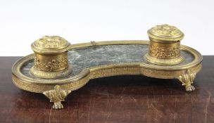 A French Empire style ormolu and marble kidney shape inkstand, on paw feet, 12.5in.