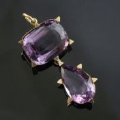 A 9ct gold and amethyst drop pendant, set with cushion and pear shaped stones within a border with