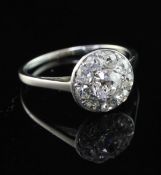 A platinum and old cut diamond cluster ring, of circular form, size N.