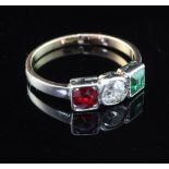 An early/mid 20th century gold and three stone emerald, diamond and red spinel ring, size H.