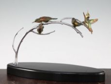 A French Art Deco silvered and painted bronze figure group, modelled as four humming birds, upon