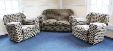 An Art Deco three piece suite, with down filled cushions and upholstered in a stylised peacock