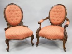 A pair of Victorian walnut lady's and gentlemans armchairs, with oval buttoned backs, his chair with