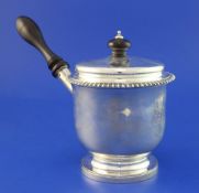 A late George III silver brandy pan and cover, with engraved armorial, gadrooned border and turned
