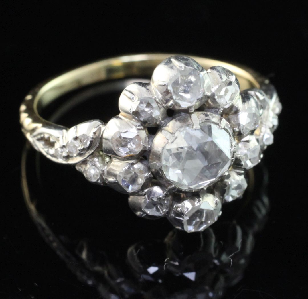 An antique style gold and silver, diamond cluster ring, set with rose cut stones, the central