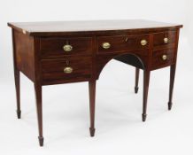 A George III mahogany bowfront sideboard, fitted with five drawers, on tapering legs and spade feet,