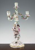 A Meissen figural four light candelabrum, late 19th century, the stem modelled with a seated man