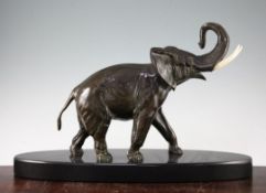 A French Art Deco patinated bronze model of a elephant, on oval polished marble base, unsigned,