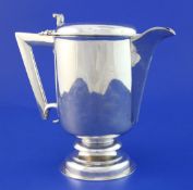 A George V Brittania standard silver ale jug, with angular handle and scroll thumbpiece,