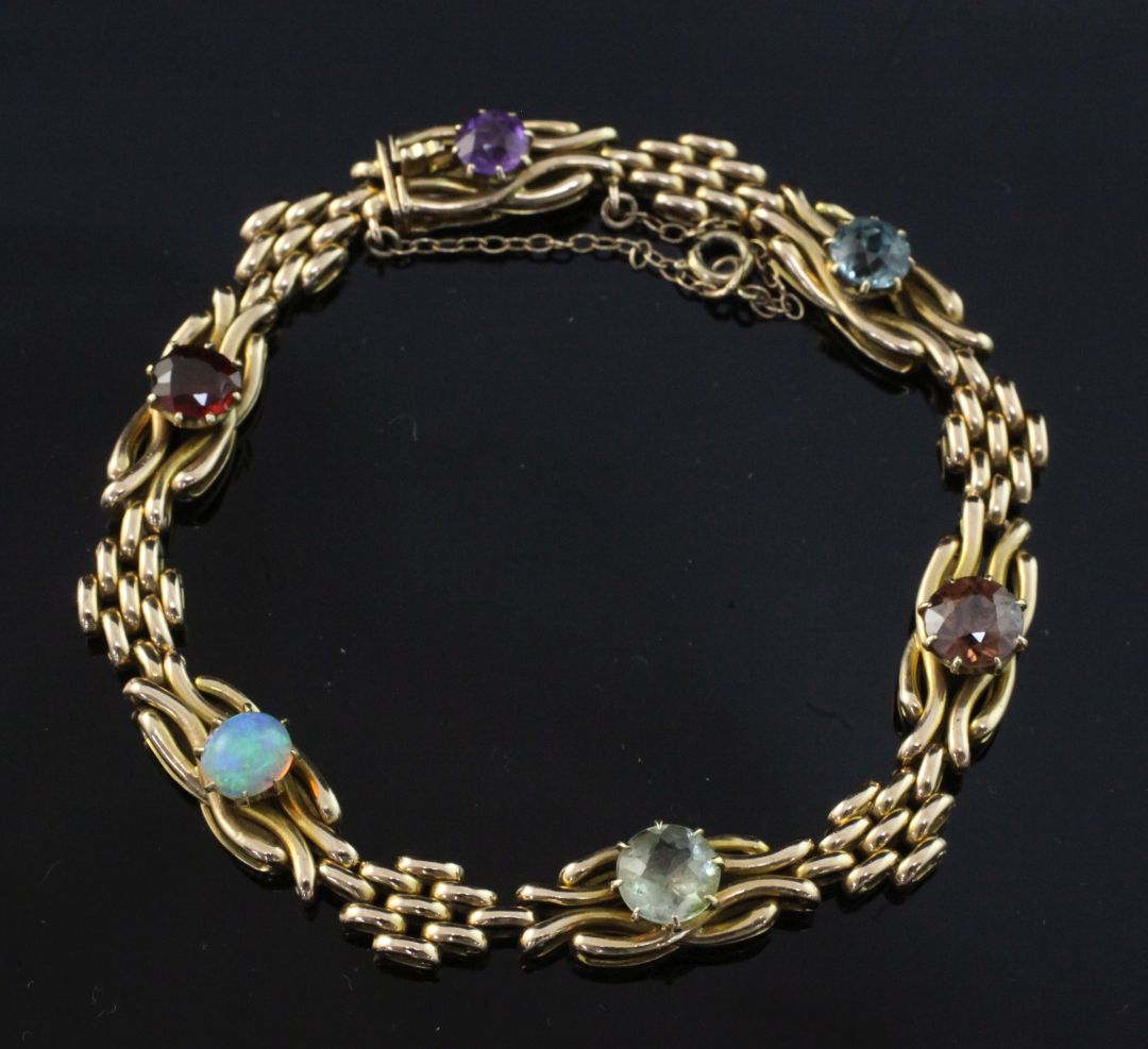 An Edwardian 15ct gold and multi gem set bracelet, including white opal, amethyst and zircon,