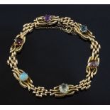 An Edwardian 15ct gold and multi gem set bracelet, including white opal, amethyst and zircon,
