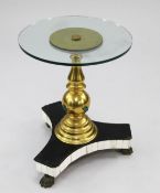 Manner of Anthony Redmile. A circular glass top occasional table, the central brass column with