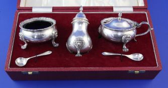 A cased late 1960's silver three piece condiment set by Roberts & Belk, with blue glass liners and