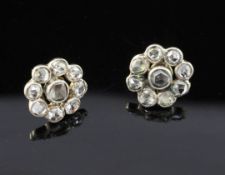 A pair of late 19th/early 20th century gold and silver rose cut diamond cluster earrings, each set