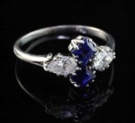 A 1940's white gold, diamond and sapphire ring, set with two square cut sapphires and two teardrop
