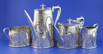 A Victorian four-piece silver tea and coffee service, of tapering oval form, with beaded panels