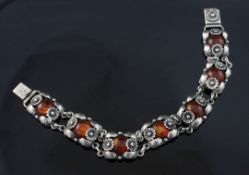 A Danish sterling silver and amber bracelet by Niels Erik From, of foliate design set with seven