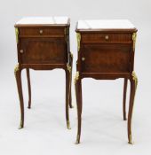 A pair of French Louis XVI style ormolu mounted kingwood bedside tables, with inset marble tops,