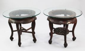 Two circular Chinese rosewood stands or tables, both with circular glass tops, one with circular