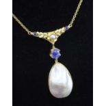 A high carat gold, baroque mabe pearl and sapphire set pendant necklace, with pierced foliate