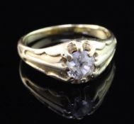 An early 20th century 18ct gold and claw set solitaire diamond ring, the old cut stone weighing