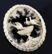 A late 19th/early 20th century ivory open work oval brooch, carved with the Pliny Doves, 1.75in.