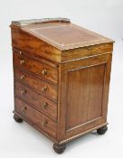 A Regency mahogany davenport, with sliding top and gilt tooled leather inset hinged writing surface,