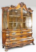 A late 18th / early 19th century Dutch bombe shaped mahogany bookcase, the arched pediment with