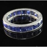 A platinum and sapphire full eternity ring, set with square cut stones, size L.