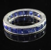 A platinum and sapphire full eternity ring, set with square cut stones, size L.
